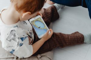 Kid engrossed in using mobile phone