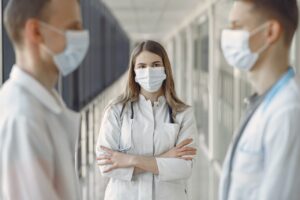 Diverse group of medical professionals in discussion at a hospital.